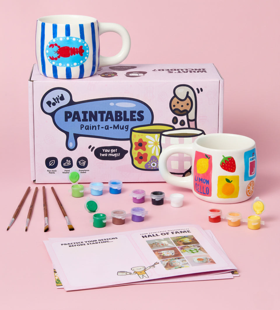 Colorful geometric-patterned pot with succulent on a white marble table in a modern bright room.